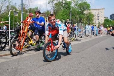 Man riding unusual  bicycle  in the center of Moscow during the festival of cycling culture in Moscow